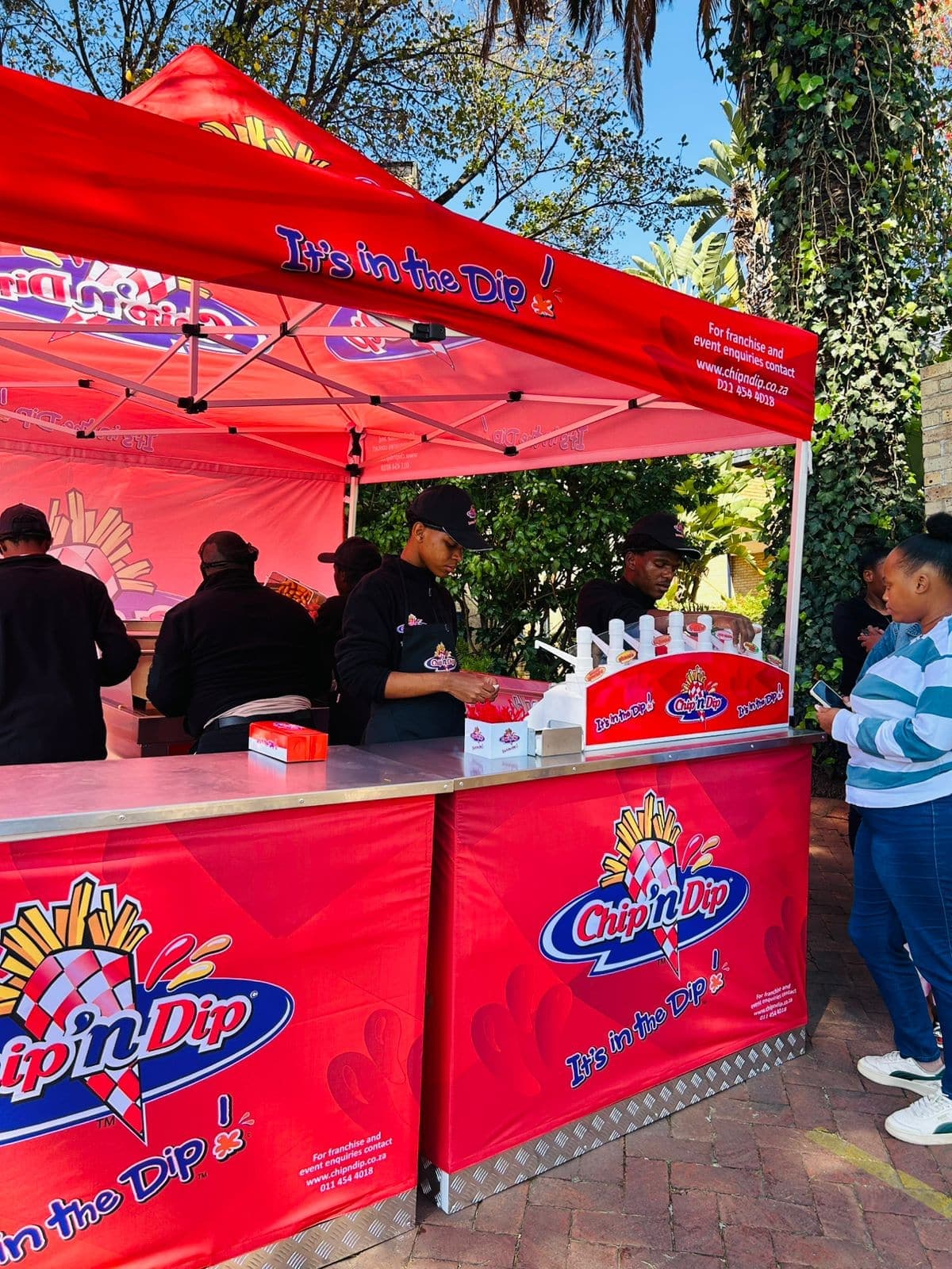 Chip 'n Dip team serving from the branded gazebo